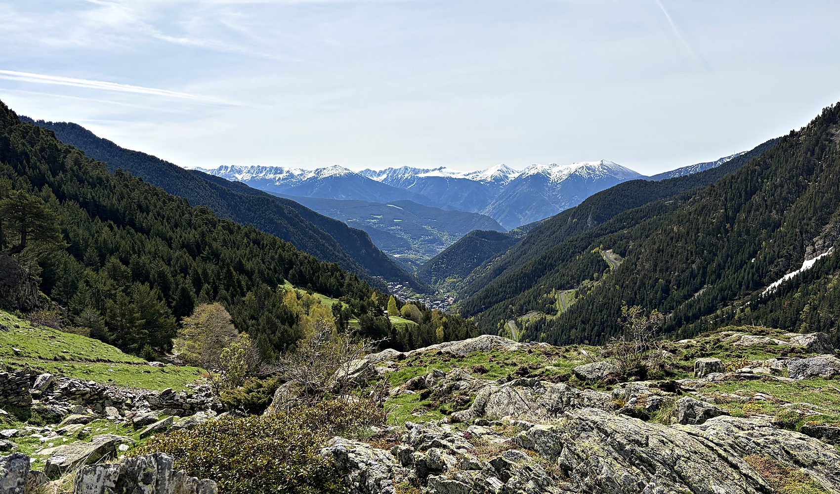 green pyrenees valley with snow-capped peaks above andorra la vella
