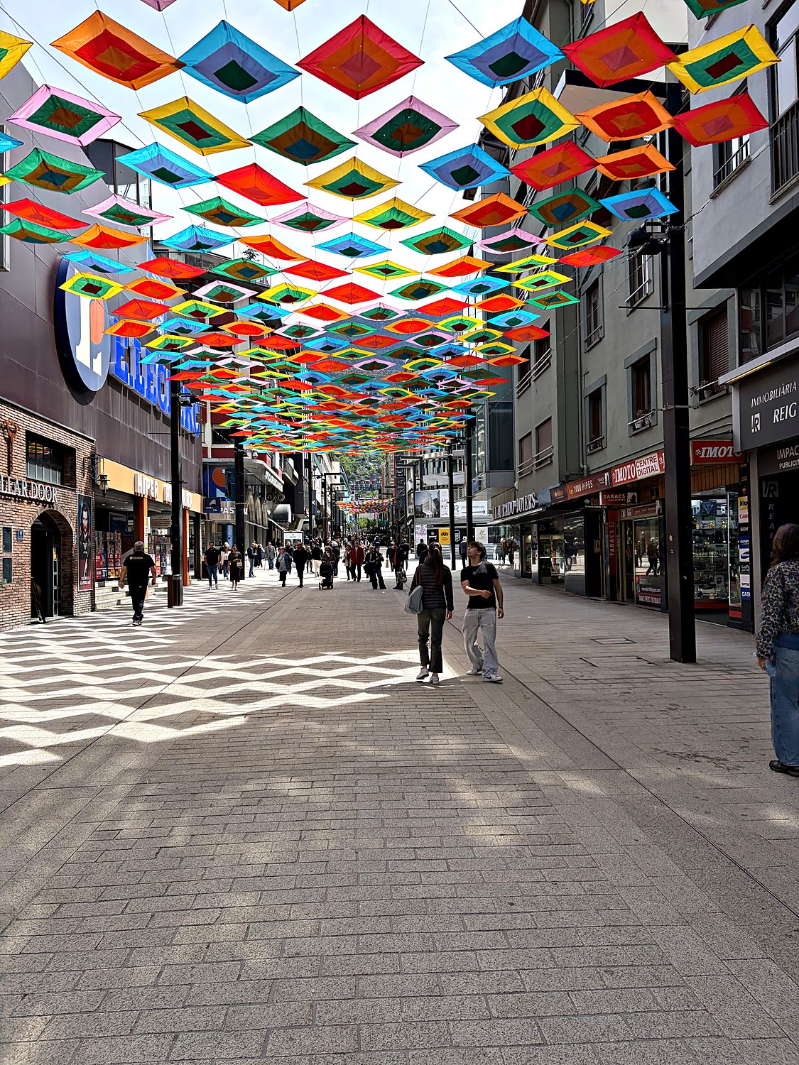 colorful canopy over the avinguda meritxell shopping street