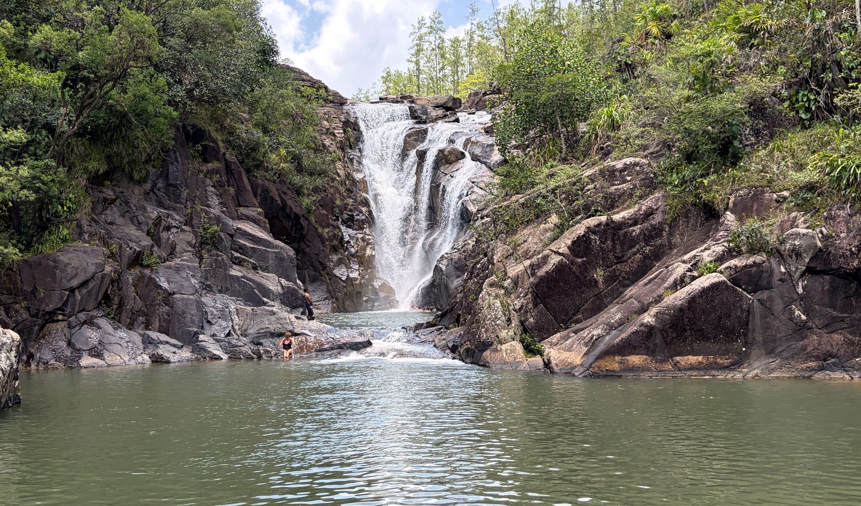 a waterfall tumbling into a jungle pool near san ignacio