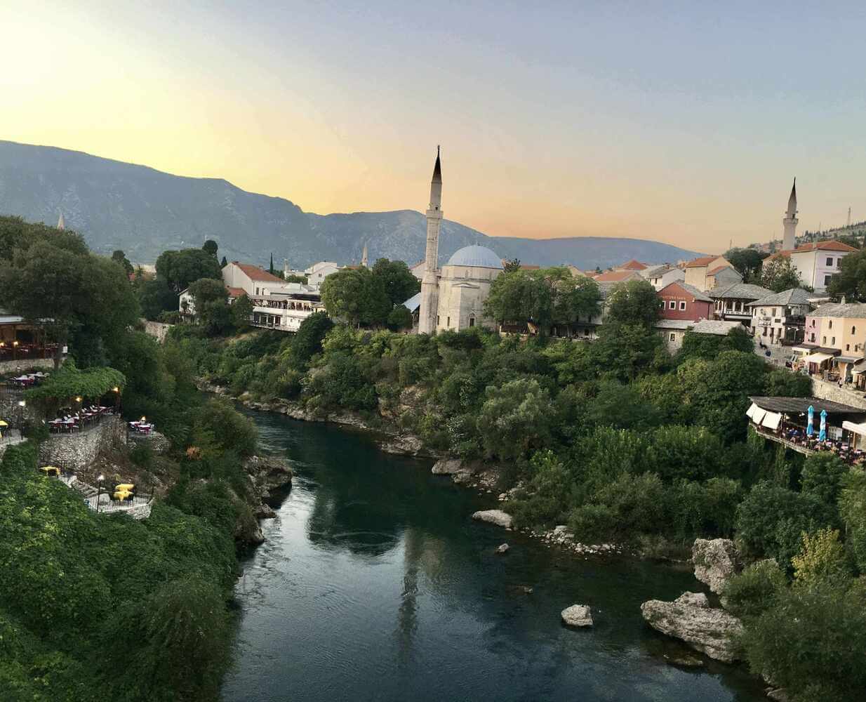 vista of mosques, river, and mountains from mostar