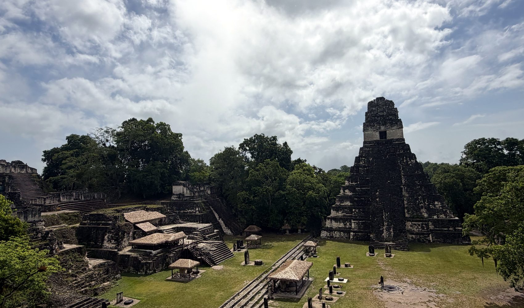 the great plaza of tikal rising above the rainforest