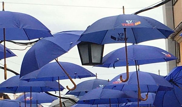 umbrellas above old city street